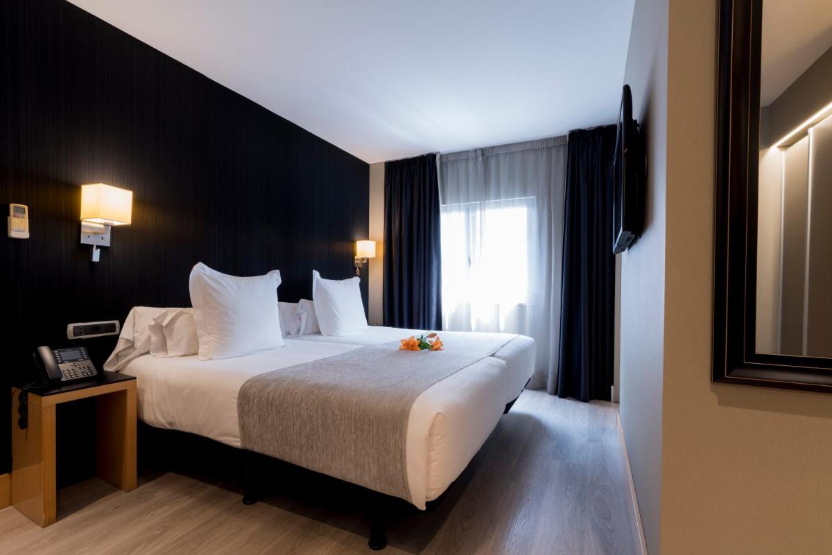 Cama o camas de una habitación en Hotel Plaza