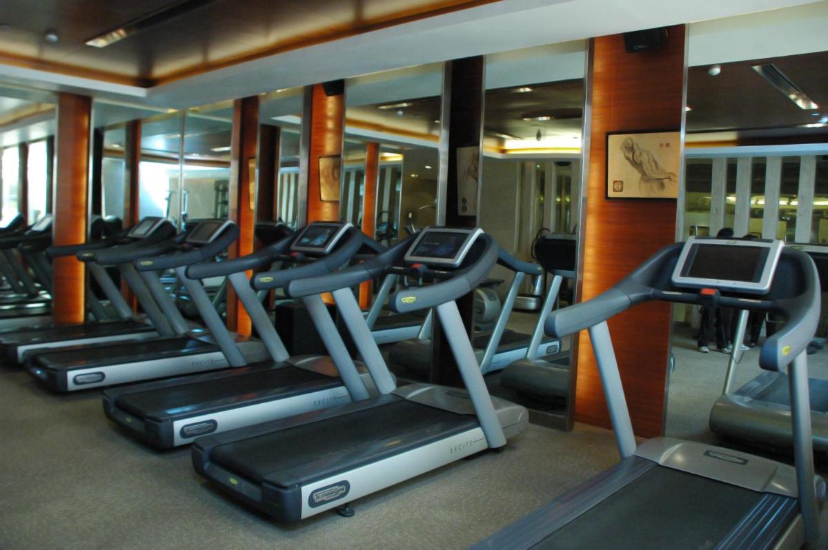 a row of tread machines in a gym at The LaLiT New Delhi in New Delhi