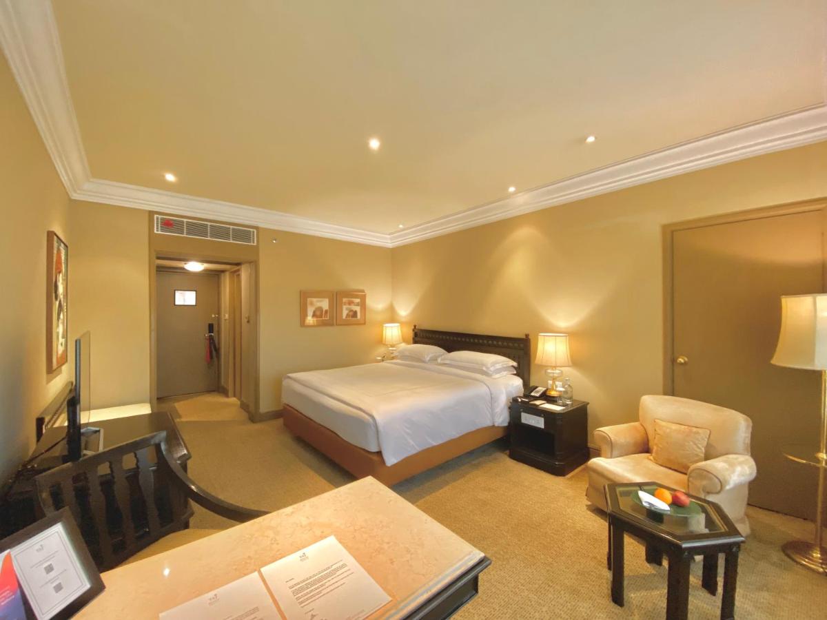 a hotel room with a bed and a desk at Taj Bengal in Kolkata