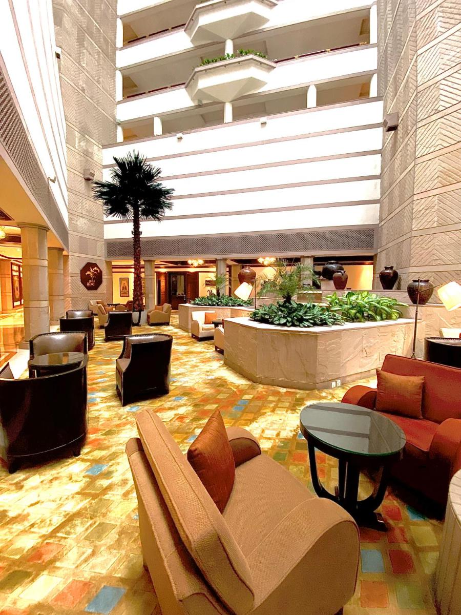 a lobby with couches and tables in a building at Taj Bengal in Kolkata
