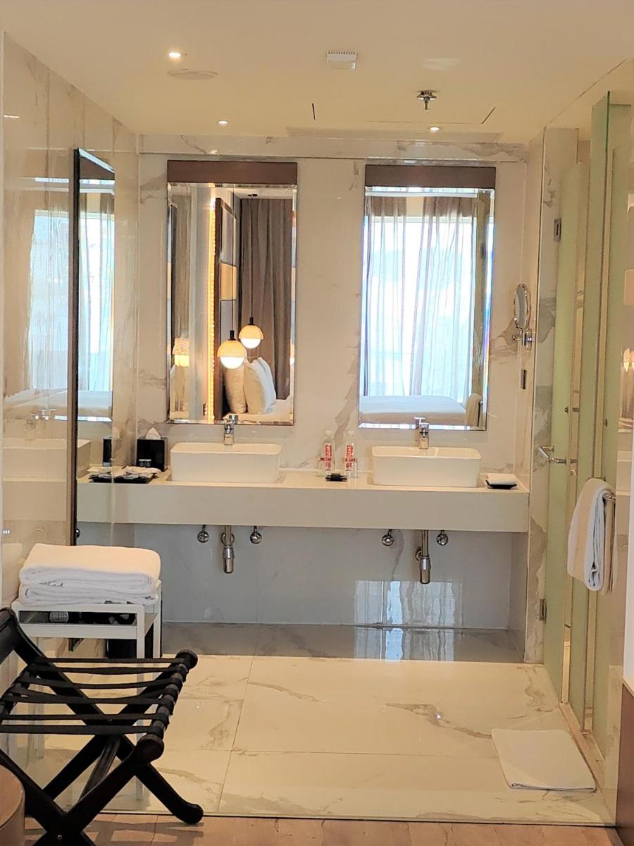 a bathroom with two sinks and a mirror at Le Meridien Hyderabad in Hyderabad