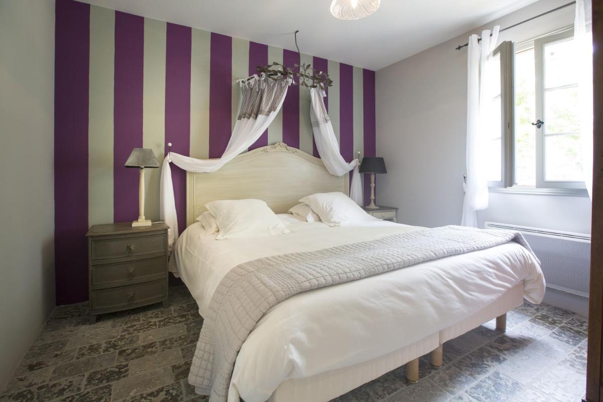Un ou plusieurs lits dans un hébergement de l'établissement Hôtel-Spa Le Saint Cirq