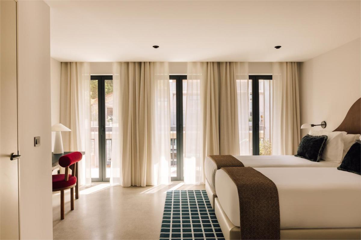 Uma cama ou camas num quarto em The Rebello Hotel & Spa - Small Luxury Hotels Of The World