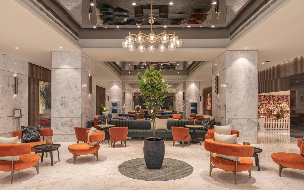 a lobby of a hotel with chairs and a waiting room at President - IHCL SeleQtions in Mumbai