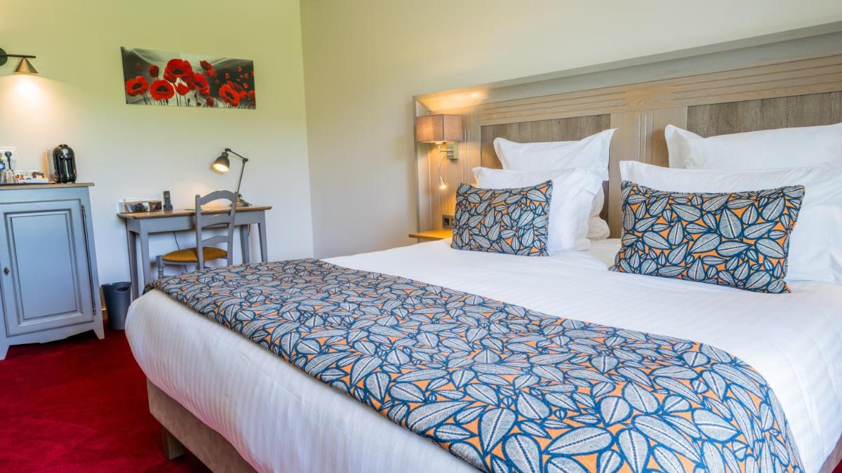 Un ou plusieurs lits dans un hébergement de l'établissement Hotel Le Perigord