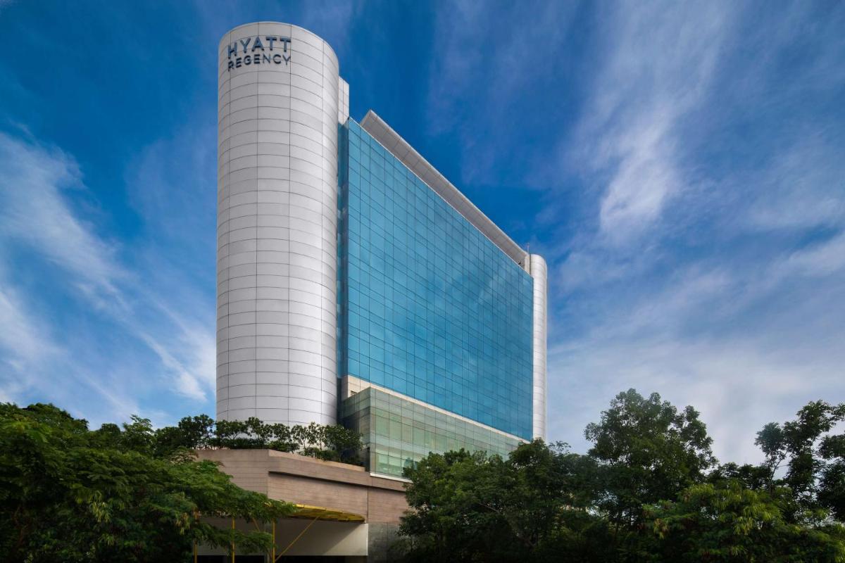 a tall white building with a sign on it at Hyatt Regency Chennai in Chennai