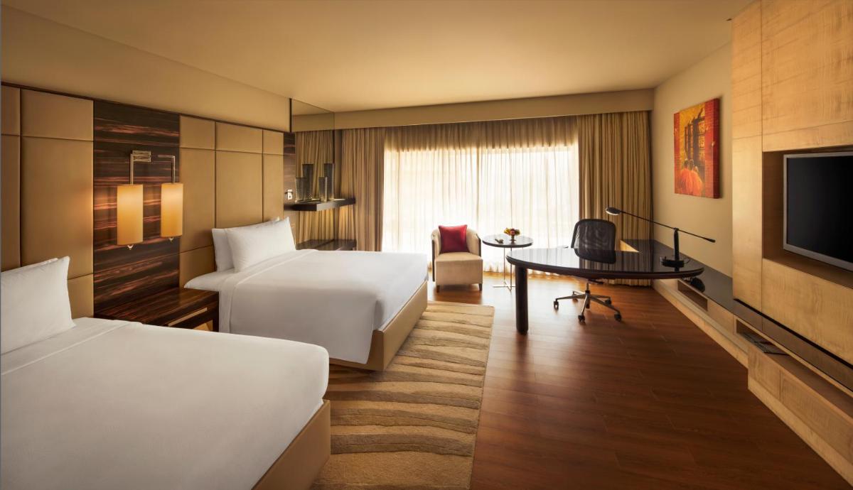a hotel room with a bed and a desk at JW Marriott Mumbai Juhu in Mumbai