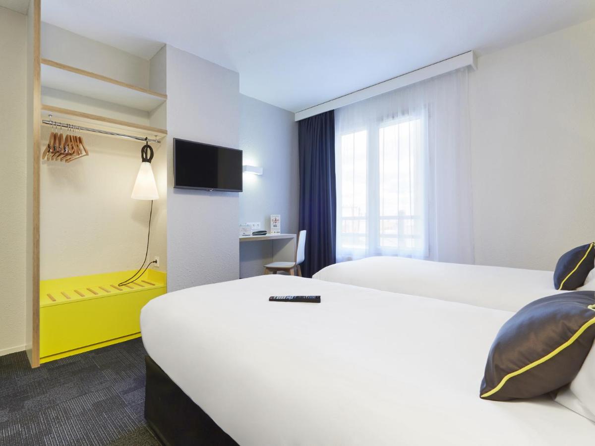 Un ou plusieurs lits dans un hébergement de l'établissement Kyriad Hotel Brest