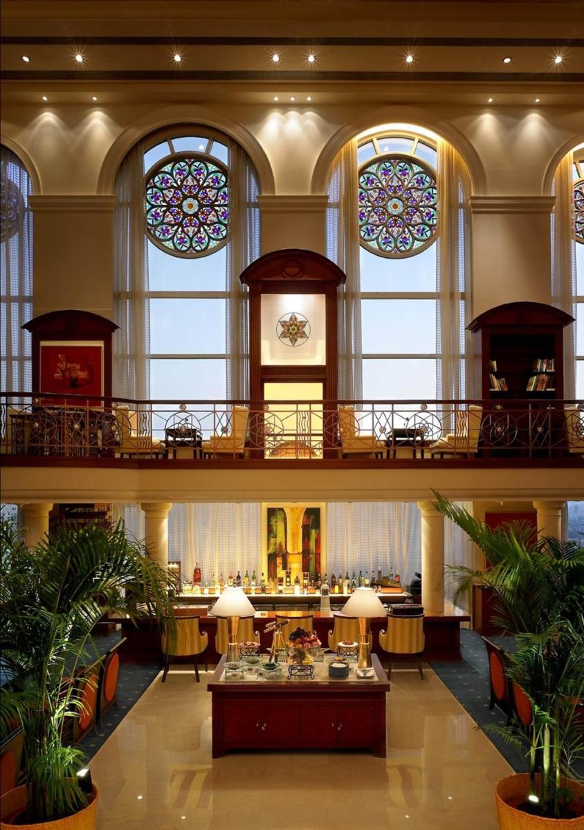 a large lobby with tables and stained glass windows at ITC Grand Central, a Luxury Collection Hotel, Mumbai in Mumbai