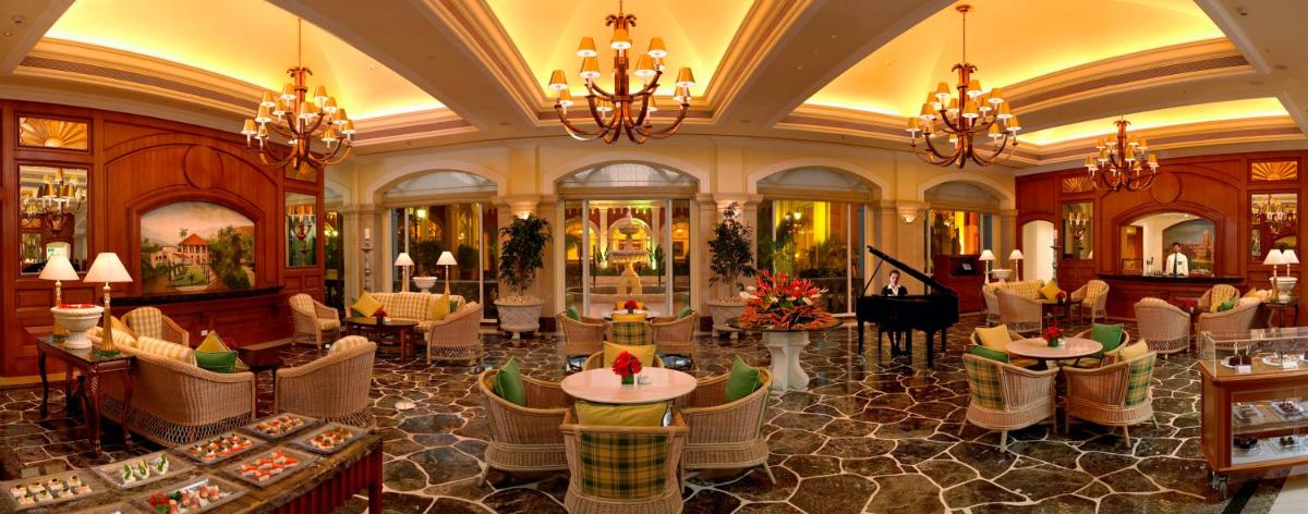a lobby of a hotel with chairs and a piano at ITC Grand Central, a Luxury Collection Hotel, Mumbai in Mumbai