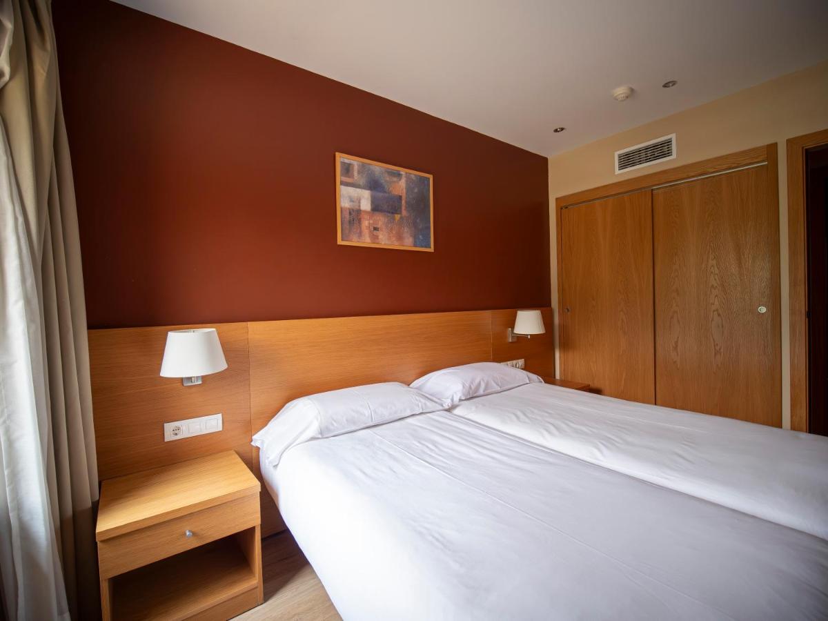 Cama o camas de una habitación en Aparthotel Siente Boí & SPA
