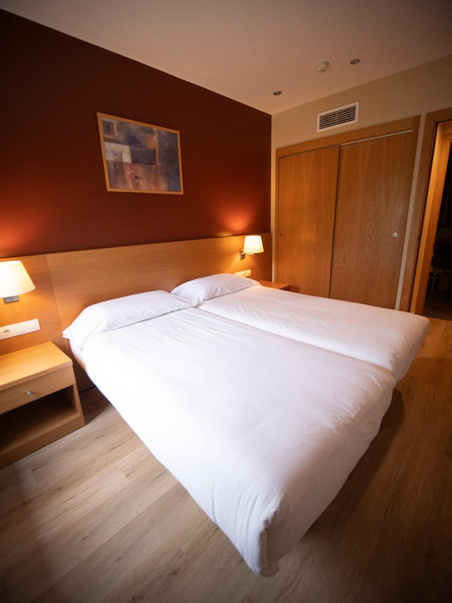 Cama o camas de una habitación en Aparthotel Siente Boí & SPA
