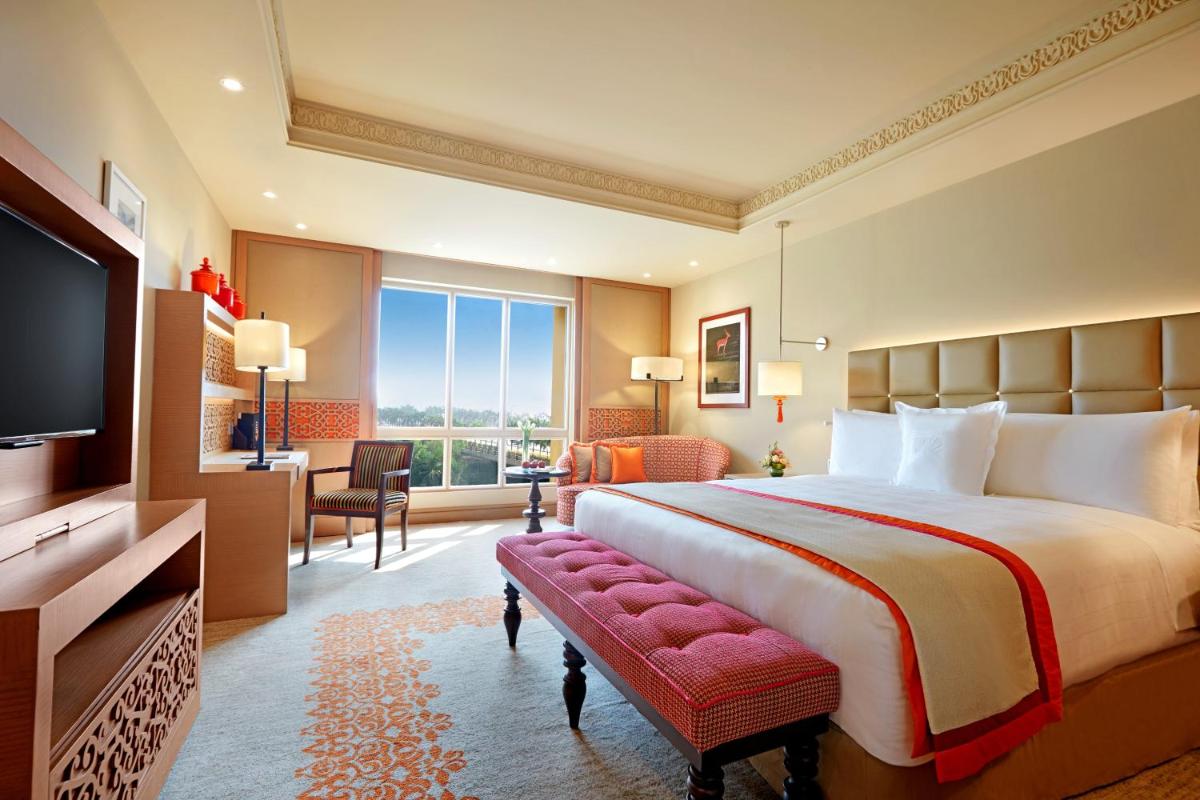 a hotel room with a large bed and a television at ITC Maratha, a Luxury Collection Hotel, Mumbai in Mumbai