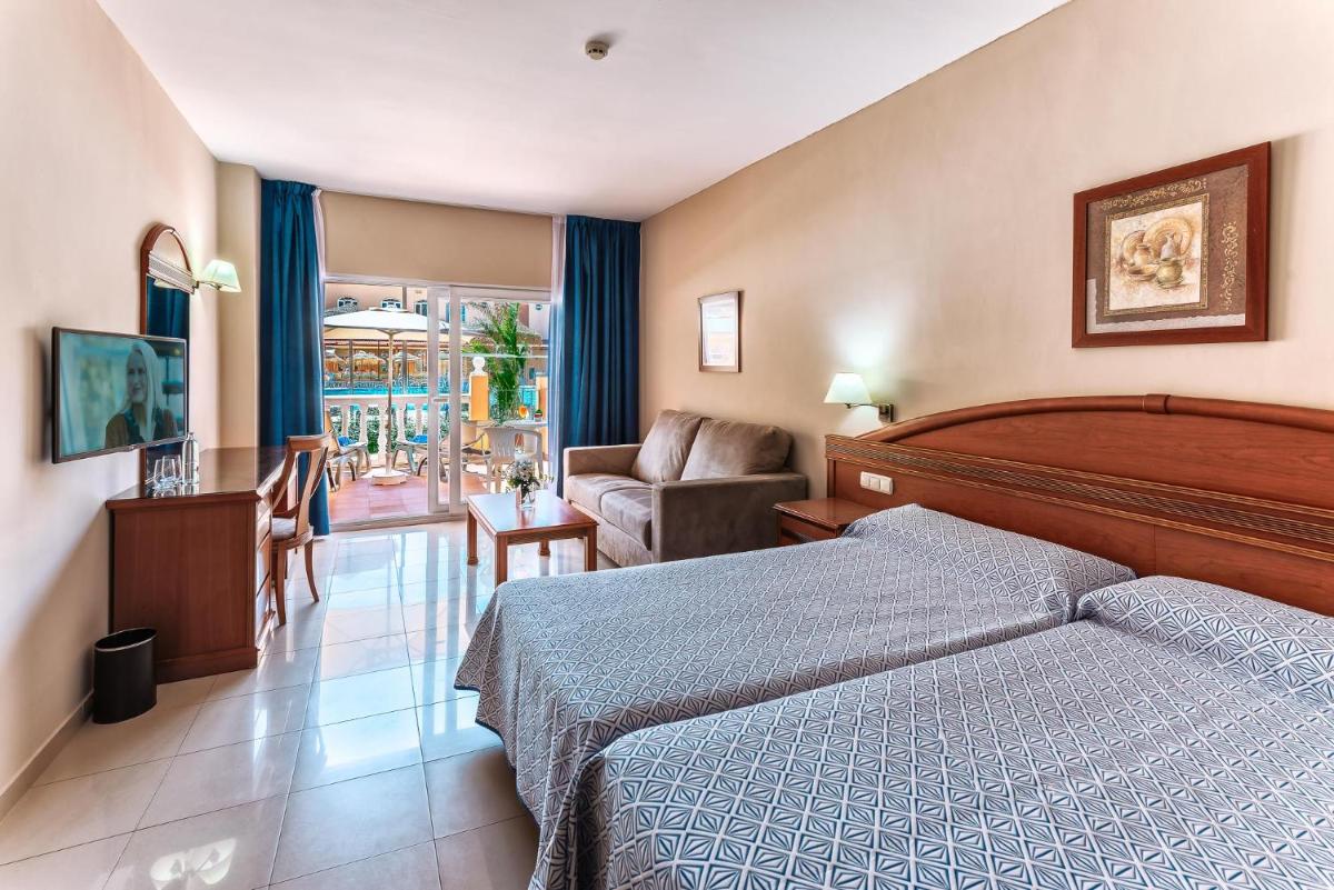 Cama o camas de una habitación en Bahía Tropical