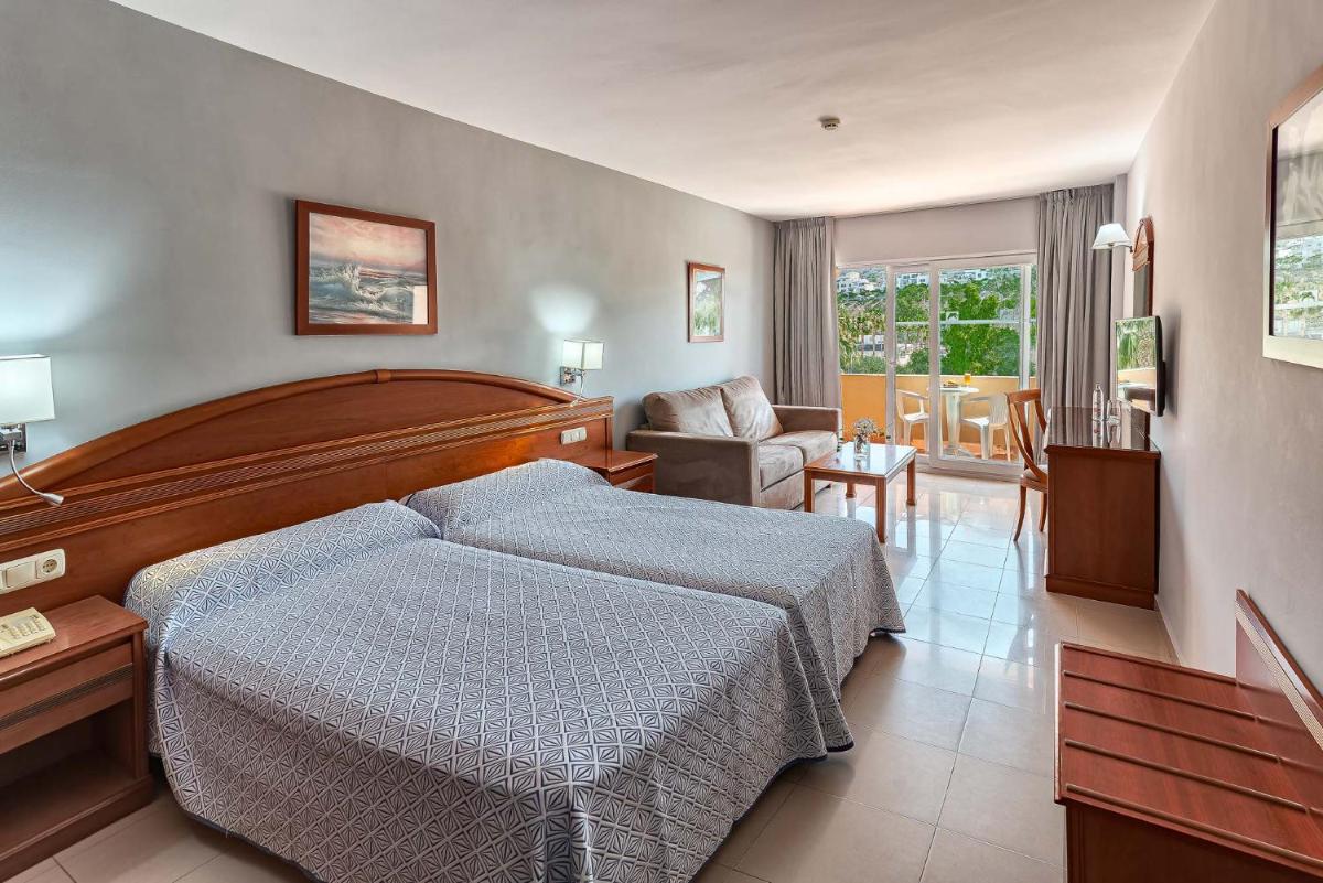 Cama o camas de una habitación en Bahía Tropical