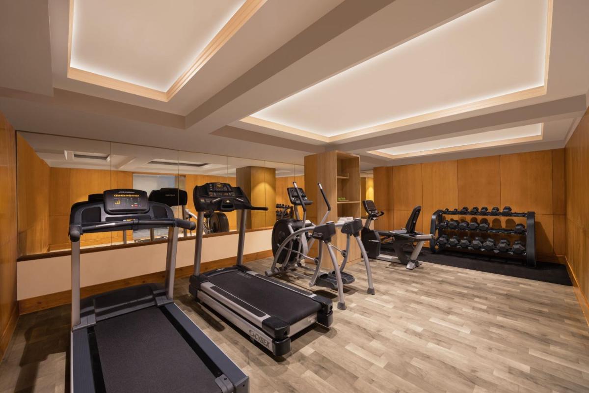 a gym with treadmills and exercise equipment in a room at Fairfield by Marriott Jaipur in Jaipur