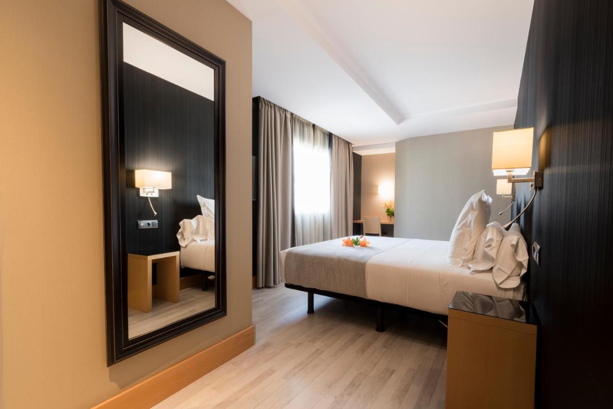 Cama o camas de una habitación en Hotel Plaza