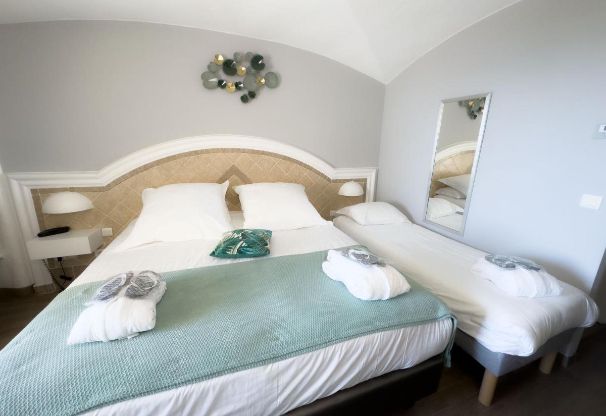 Un ou plusieurs lits dans un hébergement de l'établissement Ostella Spa & Resort