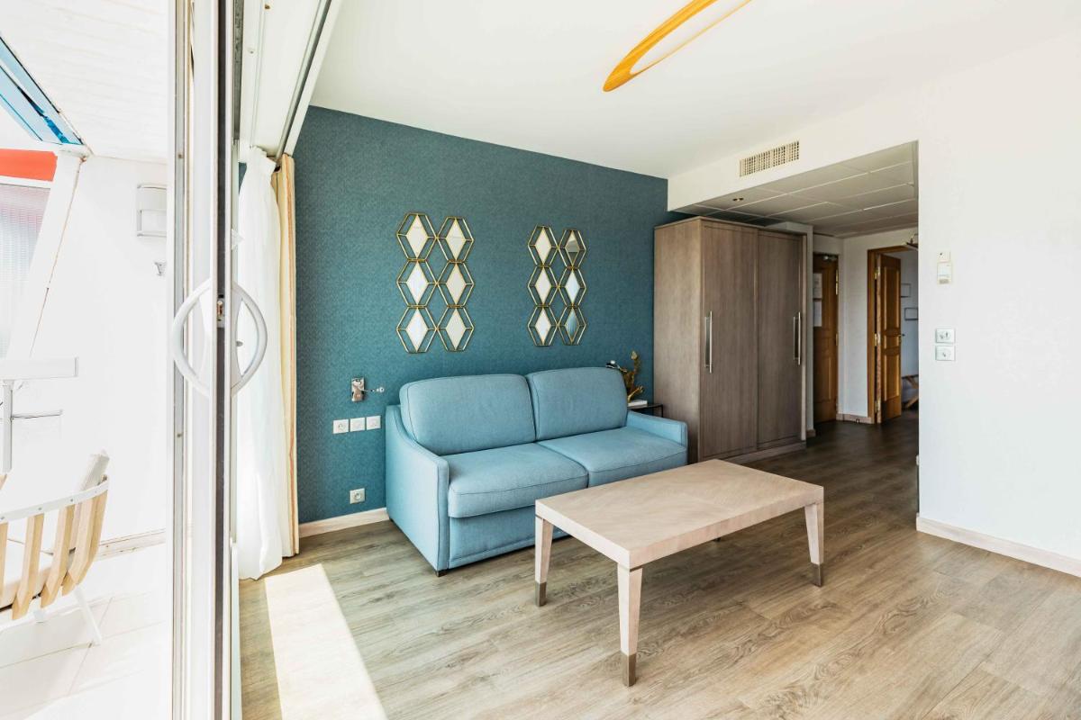 Coin salon dans l'établissement Le Diana Hôtel & Spa