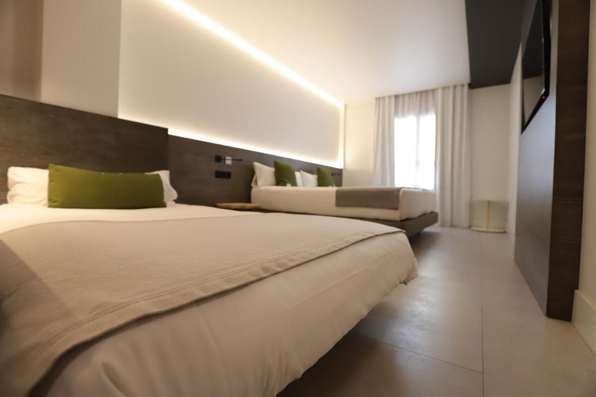 Cama o camas de una habitación en MYR Plaza Mercado & Spa