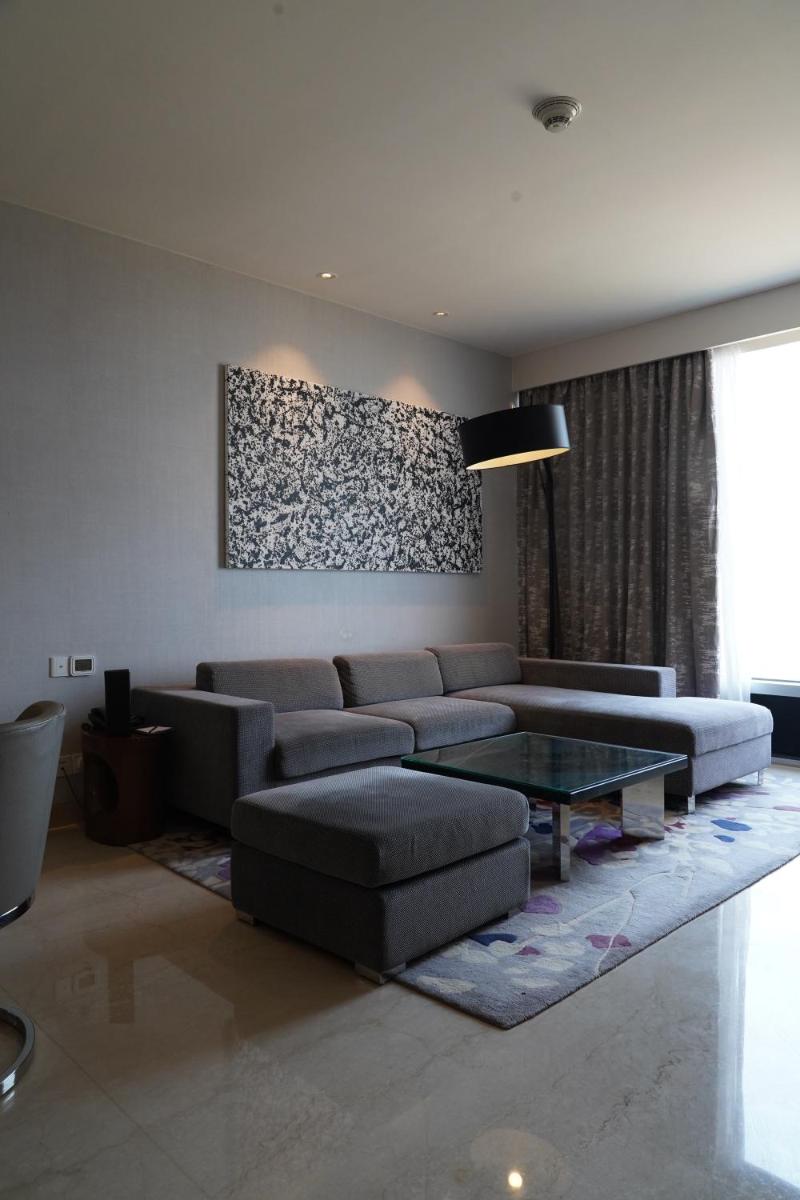 a living room with a couch and a table at Marriott Executive Apartments Hyderabad in Hyderabad