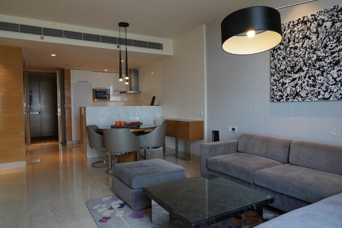 a living room with a couch and a table at Marriott Executive Apartments Hyderabad in Hyderabad