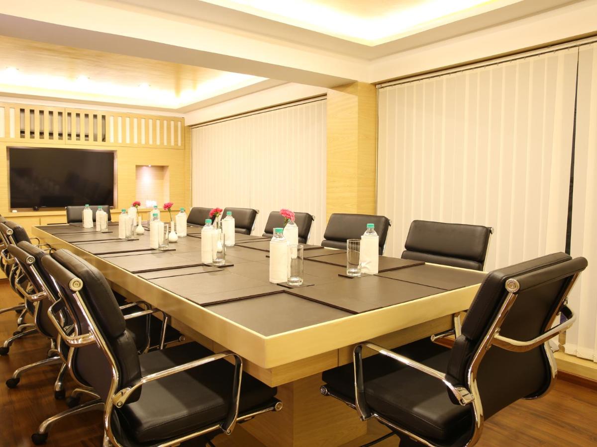 a large conference room with a large table and chairs at Deltin Suites in Candolim +27 photos