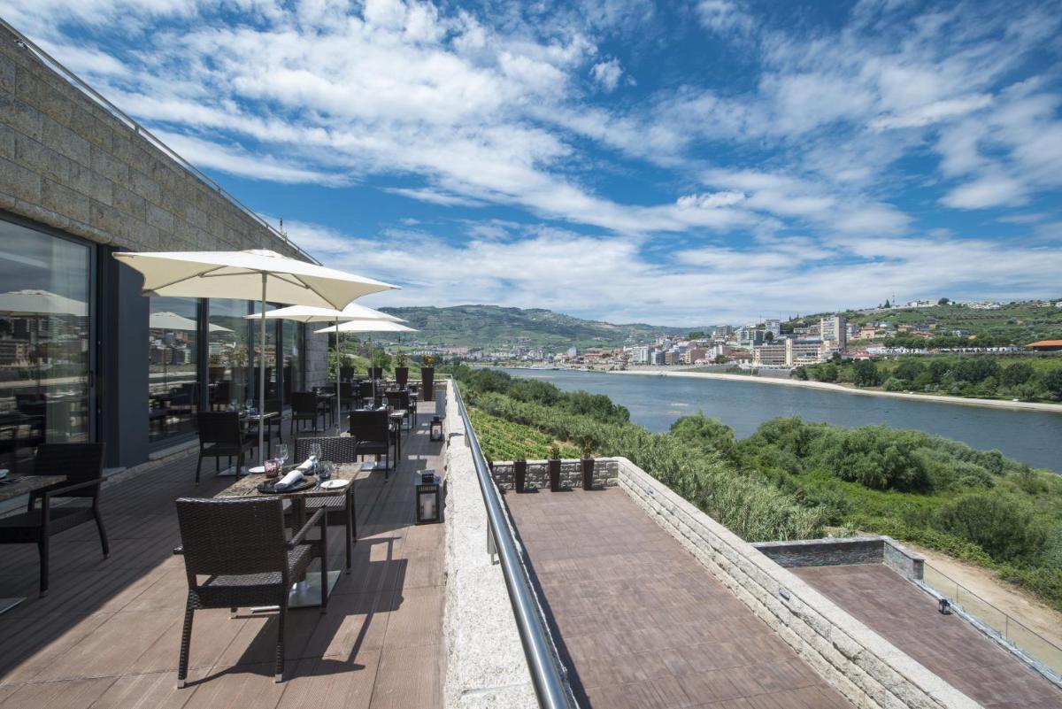 um restaurante com vista para um rio em Vila Gale Collection Douro em Lamego