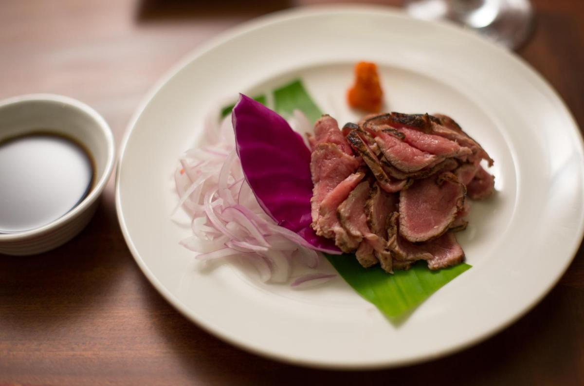 a plate of food with meat and rice on a table at The Accord Metropolitan in Chennai