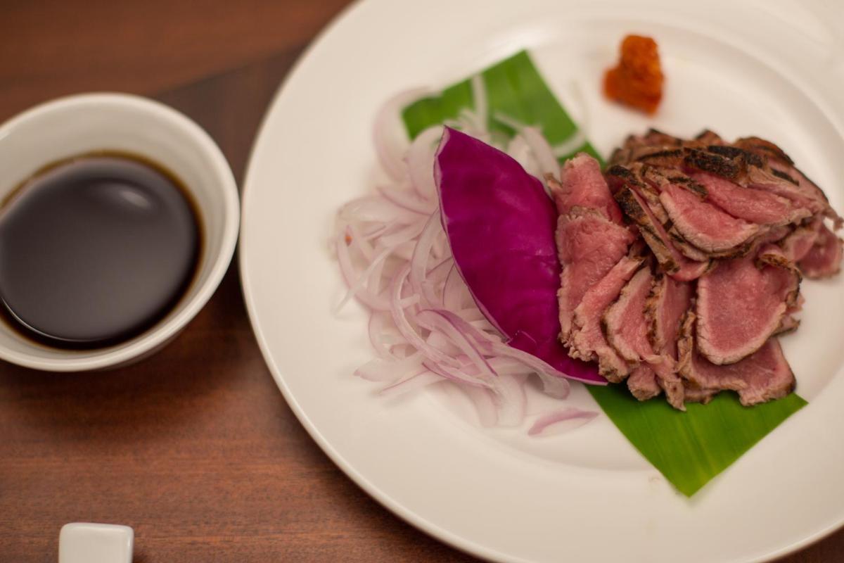 a plate of food with meat and a cup of coffee at The Accord Metropolitan in Chennai