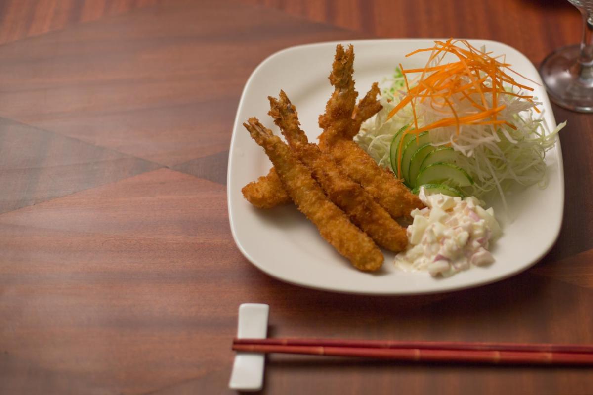 a plate of food with a salad and fried food at The Accord Metropolitan in Chennai