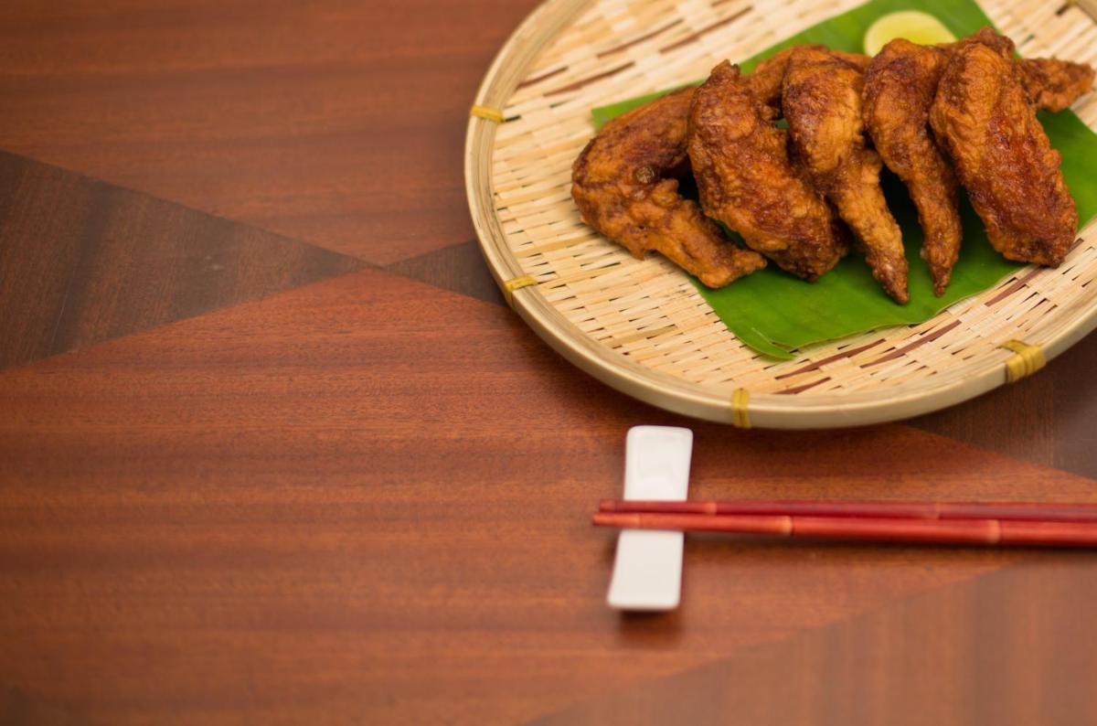 a plate of food on a wooden table with chopsticks at The Accord Metropolitan in Chennai