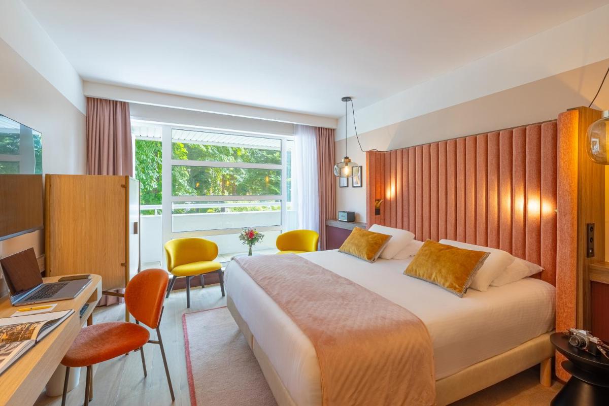 Un ou plusieurs lits dans un hébergement de l'établissement Le Riviera - Hôtel Restaurant & Spa - Ex Golden Tulip Aix les bains