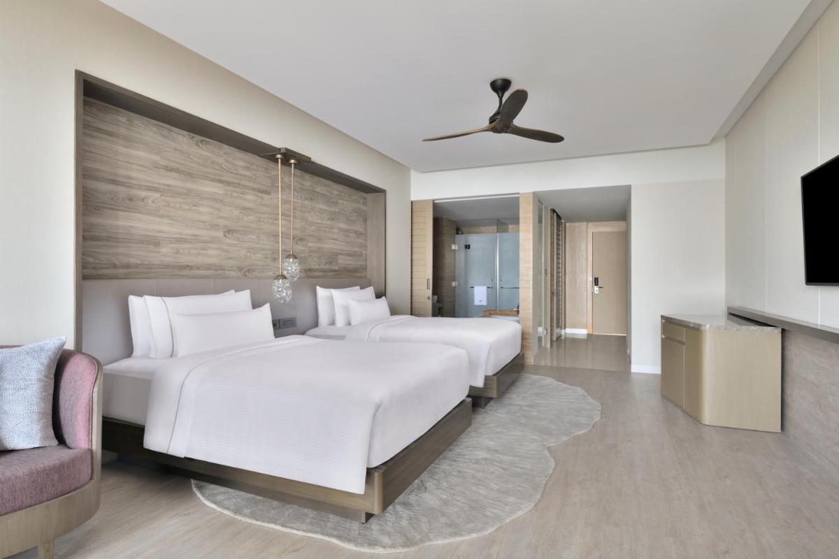 a hotel room with two beds and a tv at The Westin Resort & Spa Himalayas in Rishīkesh