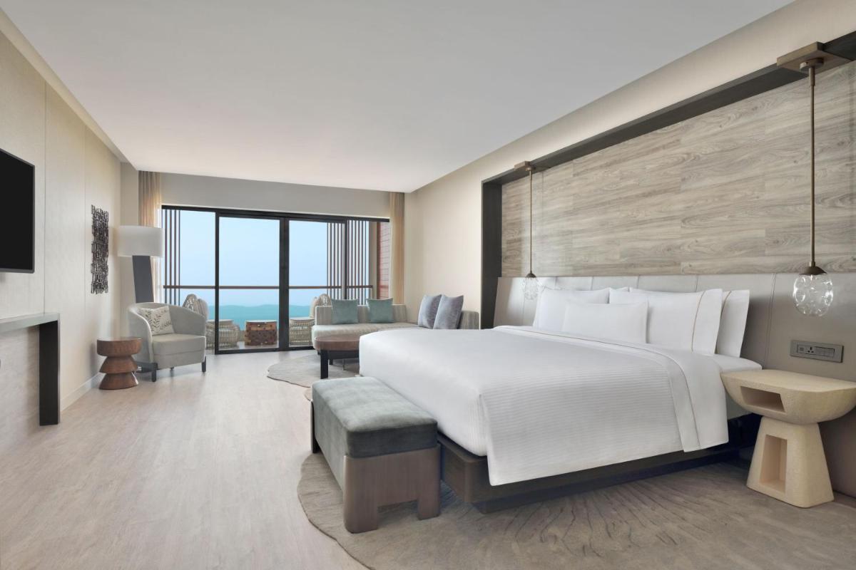 a bedroom with a large bed and a living room at The Westin Resort & Spa Himalayas in Rishīkesh