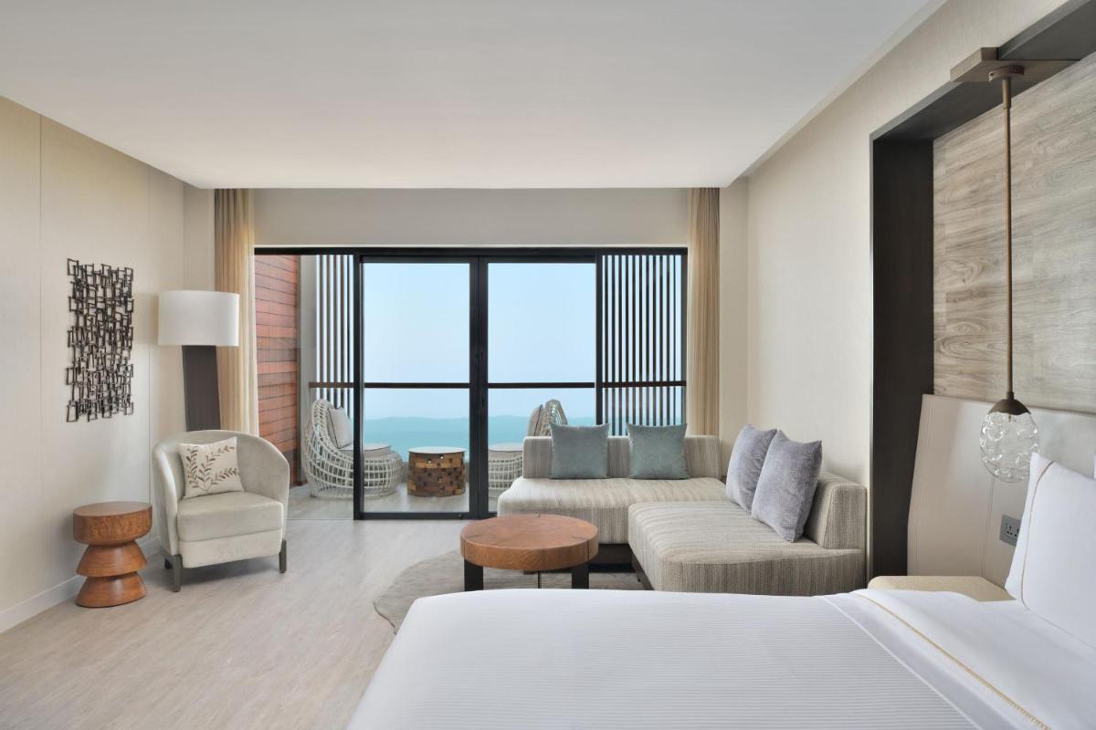 a bedroom with a bed and a living room at The Westin Resort & Spa Himalayas in Rishīkesh