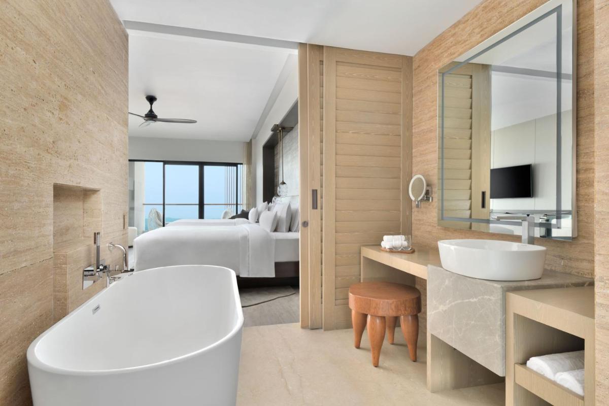 a bathroom with a tub and a sink and a bed at The Westin Resort & Spa Himalayas in Rishīkesh