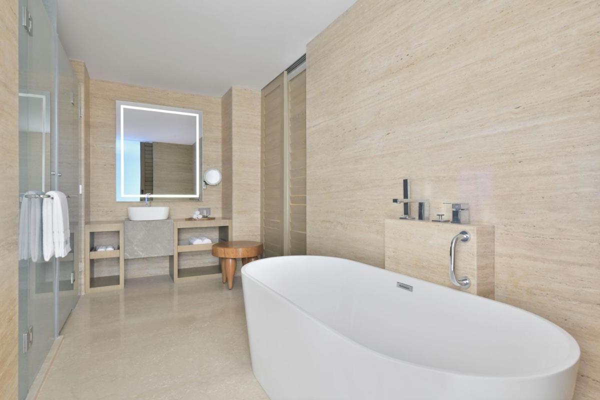a bathroom with a white tub and a sink at The Westin Resort & Spa Himalayas in Rishīkesh