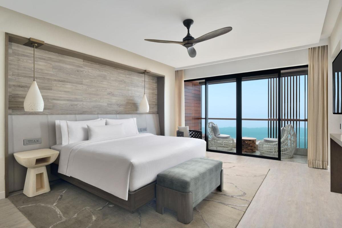 a bedroom with a white bed and a large window at The Westin Resort & Spa Himalayas in Rishīkesh