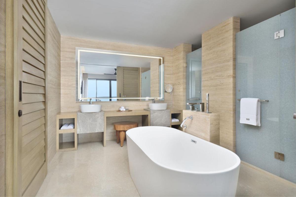 a bathroom with a tub and a sink and a mirror at The Westin Resort & Spa Himalayas in Rishīkesh