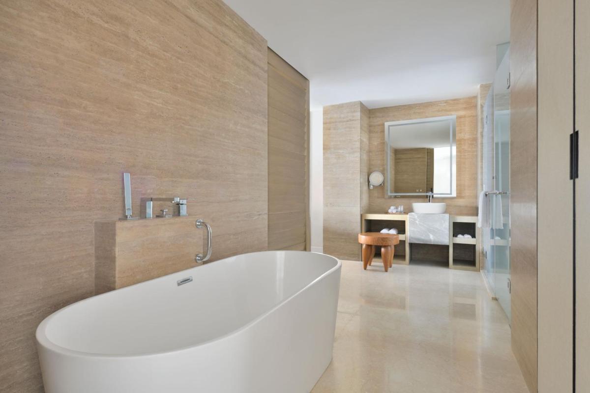a bathroom with a white tub and a sink at The Westin Resort & Spa Himalayas in Rishīkesh