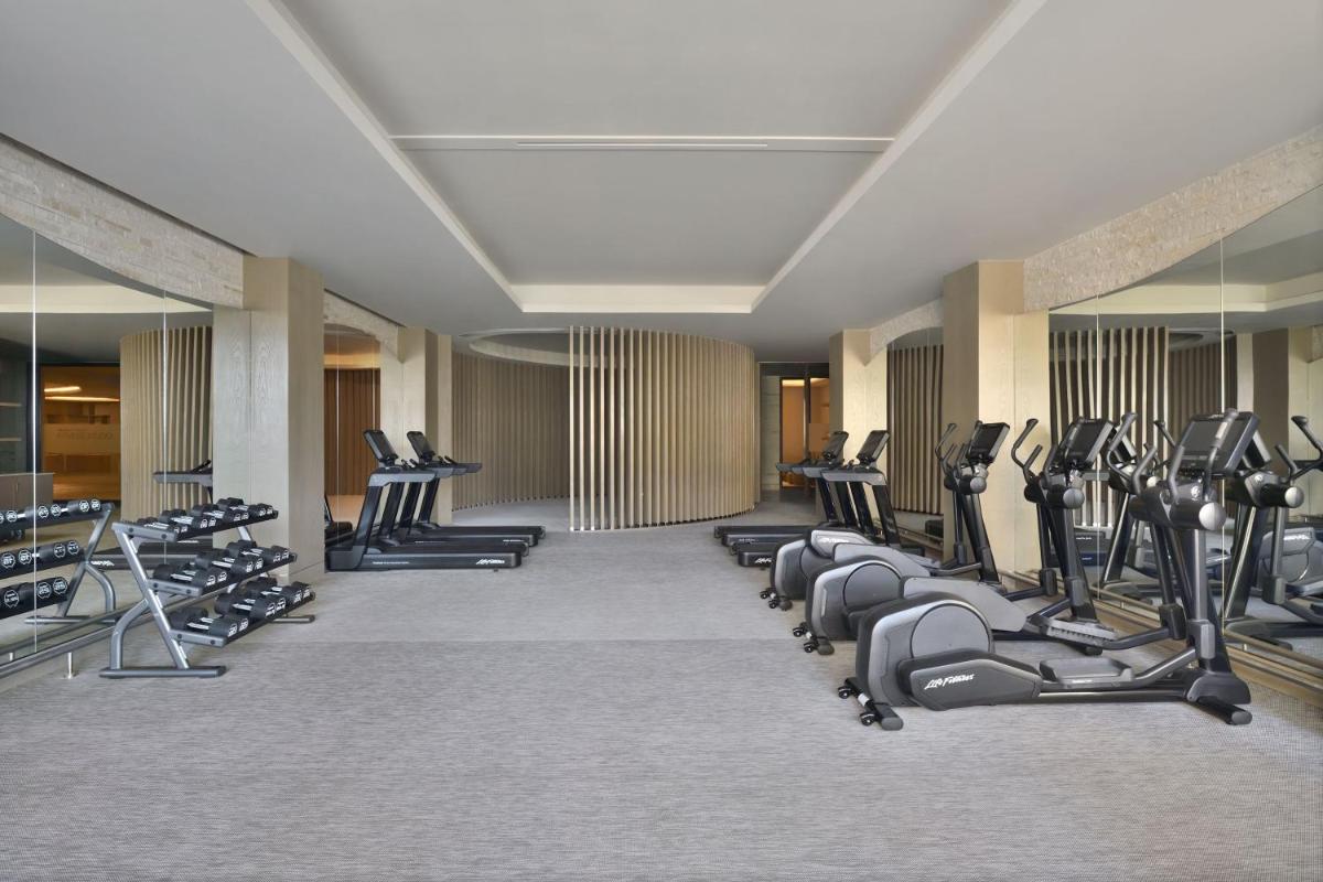 a gym with rows of treadmills and exercise bikes at The Westin Resort & Spa Himalayas in Rishīkesh