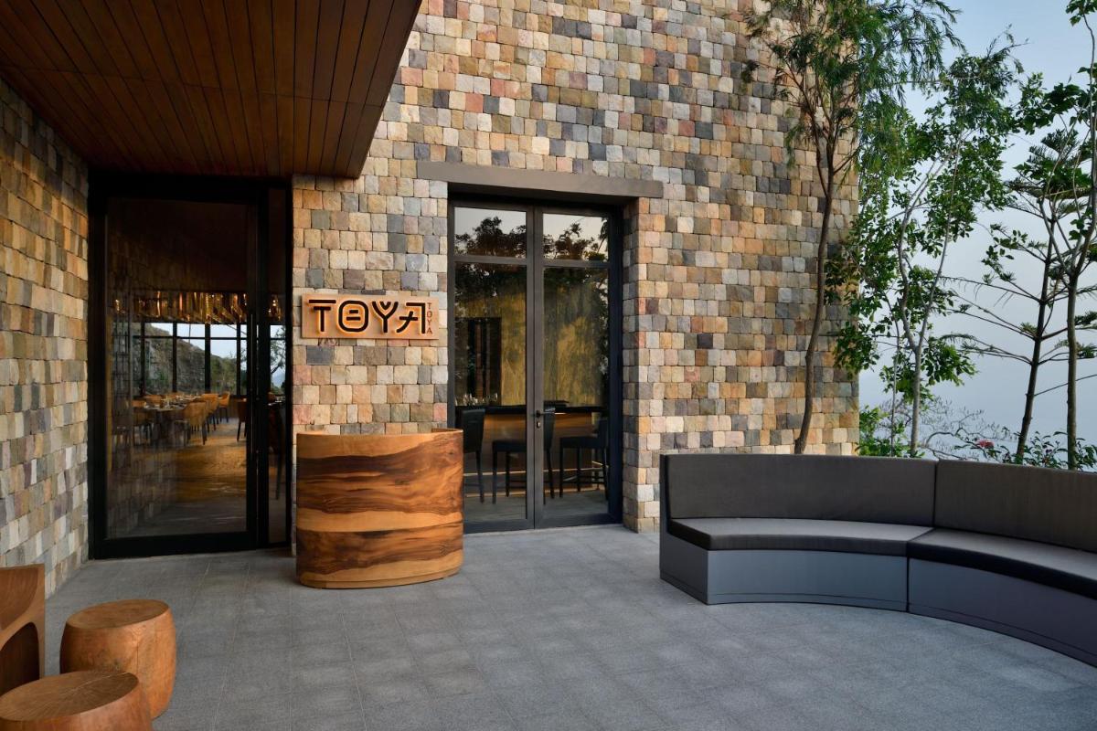 a patio with a couch and a sign on a building at The Westin Resort & Spa Himalayas in Rishīkesh