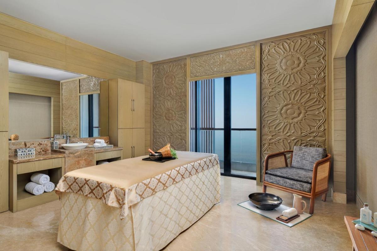 a bathroom with a table and a chair in a room at The Westin Resort & Spa Himalayas in Rishīkesh
