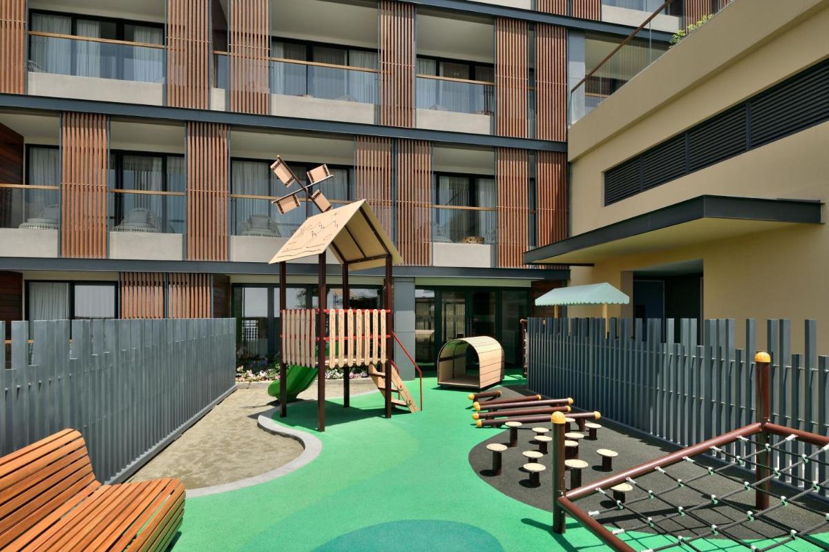 a playground in front of a building at The Westin Resort & Spa Himalayas in Rishīkesh