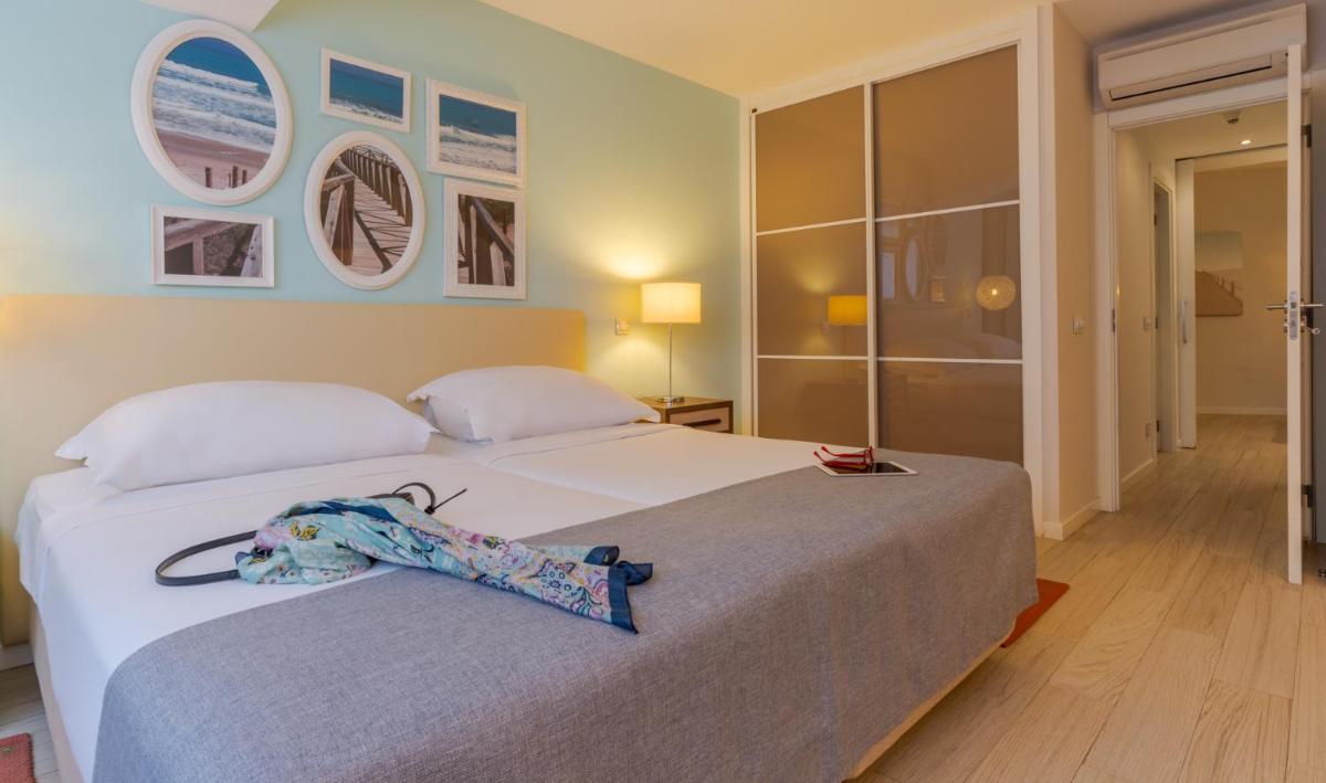 Uma cama ou camas num quarto em Pestana Alvor Praia Premium Beach & Golf Resort