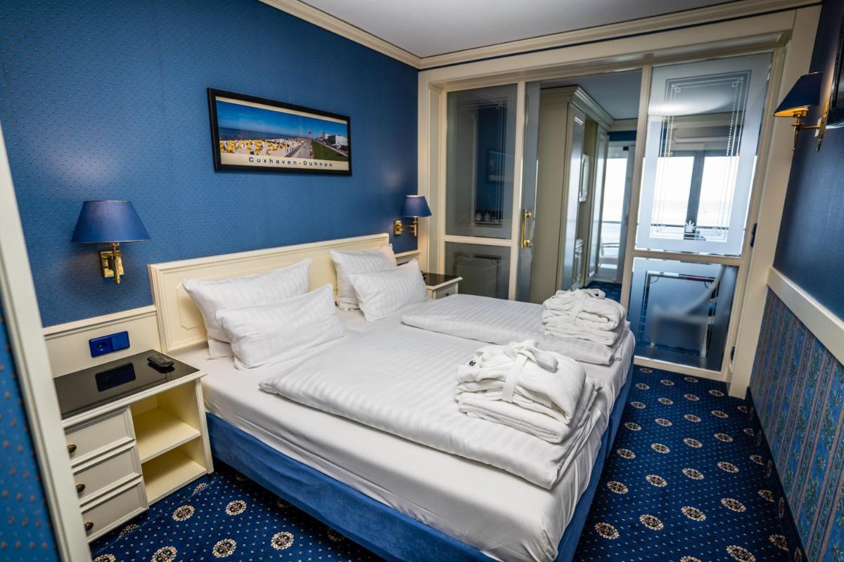 Ein Bett oder Betten in einem Zimmer der Unterkunft Hotel Strandperle
