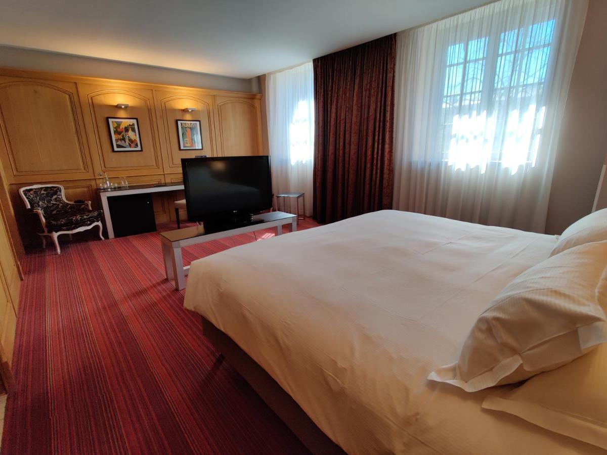 une chambre d'hôtel avec un lit et une télévision à écran plat dans l'établissement Hôtel de Bourgtheroulde, Autograph Collection, à Rouen 59 autres photos