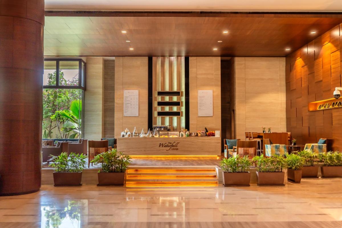 a lobby of a hotel with a restaurant at Hyatt Pune in Pune