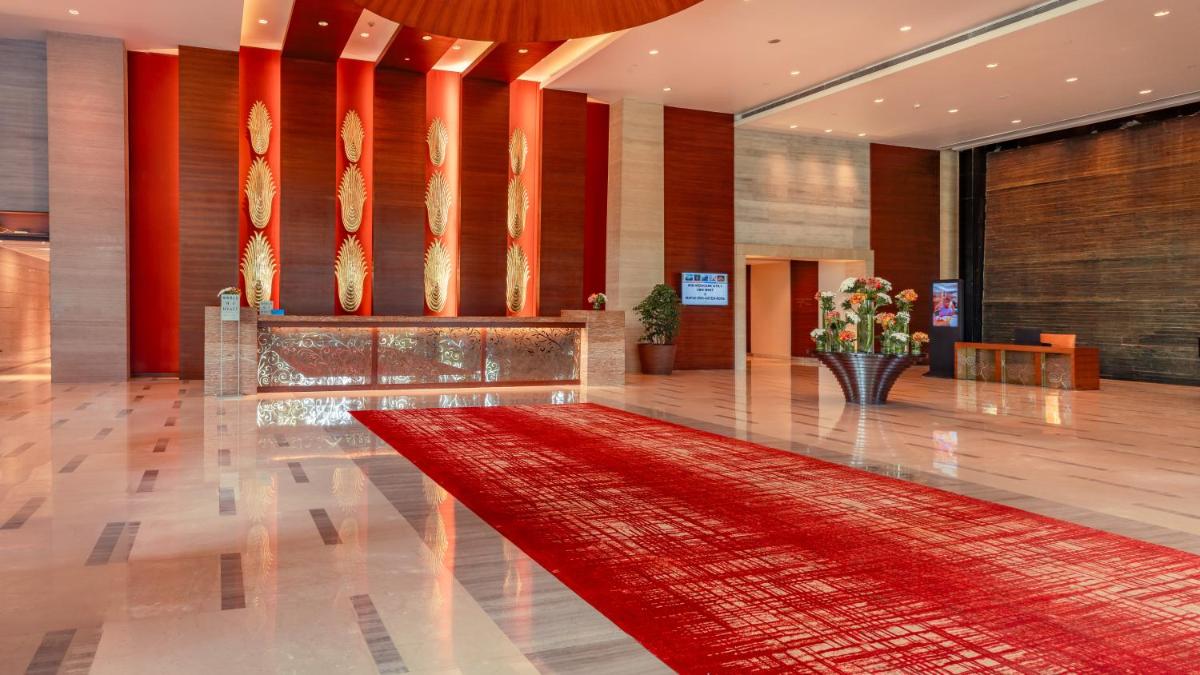 a lobby with a red rug on the floor at Hyatt Pune in Pune